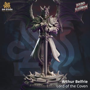 May include: A grey 3D printed miniature of a figure with wings, a crown, and a sword. The figure is standing on a circular base. The text "Arthur Belfrie Lord of the Coven" is printed below the base. The figure is from the game "Bound in the Bloodmoon".