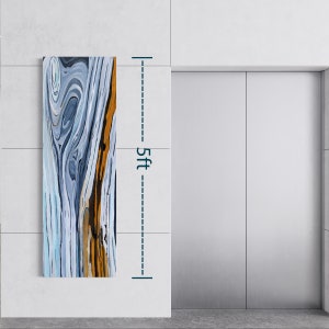 May include: Abstract painting on canvas with swirling blue, white, and gold patterns. The painting is 5 feet tall and hangs on a white wall.