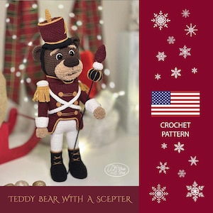Może przedstawiać: Wzór na szydełku na pluszowego misia ubranego w żołnierza zabawkę, trzymającego berło. Miś nosi czerwony i biały mundur z złotymi ozdobami. Wzór jest dostępny do pobrania. CROCHET PATTERN