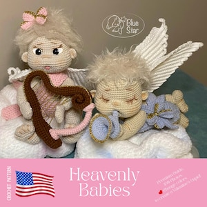 Op de afbeelding: Twee gehaakte engelpoppen, een met een strik en harp, de andere met een trompet. De poppen zijn beige met witte vleugels en accenten van roze, bruin en goud. De tekst "Heavenly Babies" en een Amerikaanse vlag staan onderaan.