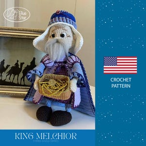 May include: Crocheted King Melchior doll from the Three Kings series. The doll wears a blue and purple robe, a matching hat, and carries a basket of gold. The doll has a long white beard and black shoes. The image also includes the text "CROCHET PATTERN".