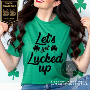 May include: A green t-shirt with the text "Let's get lucked up" in black lettering. The shirt features a shamrock design on either side of the text. The t-shirt is being worn by a person with long dark hair.