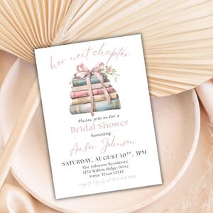 May include: A bridal shower invitation with a stack of books tied with a pink ribbon and flowers. The invitation reads "her next chapter" and includes the details for the event: "Please join us for a Bridal Shower honoring Amber Johnson, Saturday, August 10th, 3PM, The Johnson Residence, 1234 Willow Ridge Drive, Irma, Texas 12345, RSVP to [phone number]"
