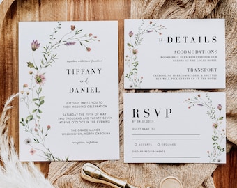 May include: A wedding invitation suite featuring floral accents and the names "Tiffany and Daniel." The set includes an invitation, details card, and RSVP card. A gold wax seal and stamp are also present, all arranged on a wooden tray.