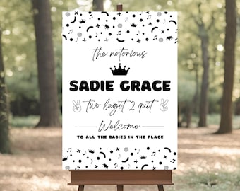 May include: A white welcome sign with black text and graphics. The text reads "The notorious Sadie Grace - Two Legit 2 Quit - Welcome - To all the babies in the place". The graphics include a crown, peace signs, musical notes, and other abstract shapes.