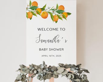 May include: White welcome sign with orange blossoms and the text "Welcome to Samantha's Baby Shower April 16th, 2025"