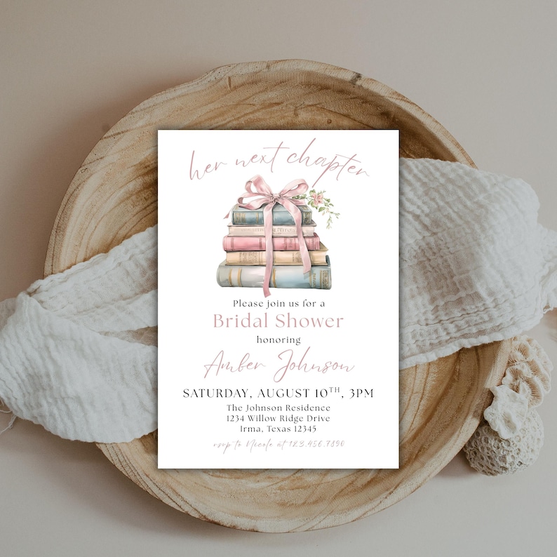 May include: A bridal shower invitation with a stack of books tied with a pink ribbon and flowers. The text reads "her next chapter" and "Please join us for a Bridal Shower honoring Amber Johnson. SATURDAY, AUGUST 10TH, 3PM. The Johnson Residence 1234 Willow Ridge Drive Irma, Texas 12345."