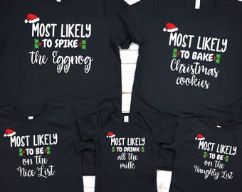 May include: Set of five black t-shirts with white text and red and green accents. The shirts say "Most Likely to Spike the Eggnog", "Most Likely to Bake Christmas Cookies", "Most Likely to Be on the Nice List", "Most Likely to Drink All the Milk", and "Most Likely to Be on the Naughty List".