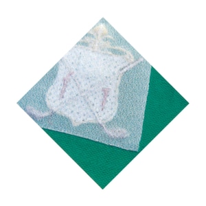 May include: A white, patterned square, semi-transparent, is layered over a green square, forming a diamond. The white layer has a delicate, textured appearance with subtle pink accents, possibly a textile or decorative element.