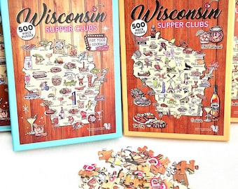 Può includere: Tre puzzle da 500 pezzi con illustrazioni di supper club del Wisconsin. I puzzle sono in scatole con sfondo blu, giallo e arancione. Le scatole sono su una superficie bianca con un mucchio di pezzi di puzzle in primo piano.