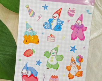 May include: A sheet of stickers featuring cartoon clown characters with various outfits and accessories. The stickers include images of clowns, cakes, stars, and party hats. The text "Cake Clowns" is at the top.