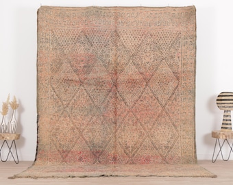 May include: A vintage Moroccan rug with a diamond pattern in shades of beige, brown, and pink. The rug has a distressed, worn look, adding to its charm.