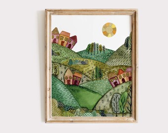 May include: Watercolour painting of a whimsical landscape with rolling green hills, small houses, and trees. A yellow and orange sun is in the sky. The artwork is framed in a light brown wooden frame.