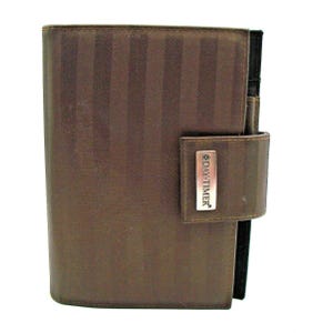 May include: A brown leather Day-Timer planner with a silver logo and a flap closure.