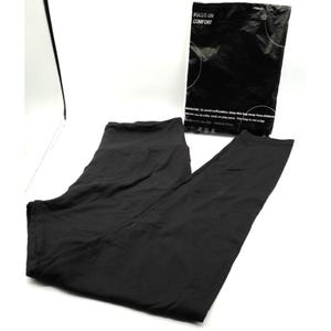 May include: Black leggings with a high waistband, lying flat on a white surface. A black plastic bag with the text "FOCUS ON COMFORT" is next to the leggings. The leggings appear to be made of a soft, stretchy material.