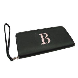 May include: Black leather wallet with a pink embroidered letter "B" and a wrist strap.