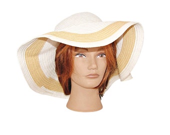 May include: A wide-brimmed sun hat with a white and tan striped design. The hat is made of straw and has a floppy brim.