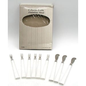 May include: A set of six white handled party forks made of stainless steel. The forks are packaged in a white box with the text "6 Party Forks Stainless Steel" printed on the front.