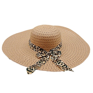 May include: A wide-brimmed straw hat with a brown and black leopard print ribbon tied in a bow.