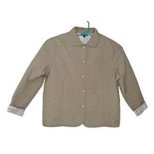 May include: A quilted jacket with a button closure and a plaid lining. The jacket is a light brown color and has a diamond pattern.