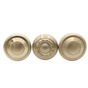 May include: Three circular cabinet knobs with a brushed gold finish. Two knobs feature a smooth, concentric stepped design, while the center knob displays a textured, rope-like border surrounding a raised, smooth circular center element.