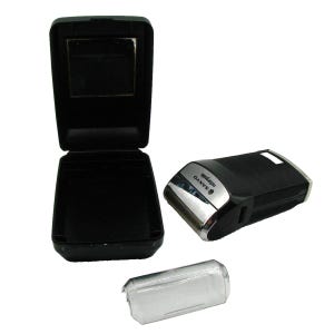 May include: A black electric razor with a silver trim and the word "SANYO" printed on it. The razor is in a black plastic case with a mirror on the inside of the lid.