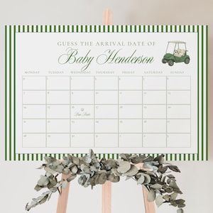 May include: A baby shower calendar with a green and white striped border. The calendar is designed to guess the arrival date of Baby Henderson. A watercolor image of a golf cart is in the upper right corner. The calendar is displayed on a wooden easel.