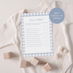 May include: A baby shower game card with a blue and white gingham border, titled "Over or Under?" The card is on a white onesie, with wooden blocks and dried flowers nearby. The text includes questions about the parents-to-be.