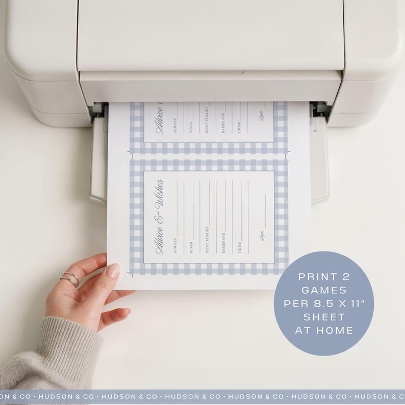 May include: A sheet of paper with two "Advice & Wishes" game templates, printed from a white printer. The templates have a light blue gingham border. The text "Print 2 games per 8.5 x 11" sheet at home" is in a blue circle.