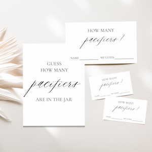 May include: White baby shower game cards with the text "Guess How Many Pacifiers Are in the Jar" and "How Many Pacifiers?" in elegant script. Includes space for name and guess.