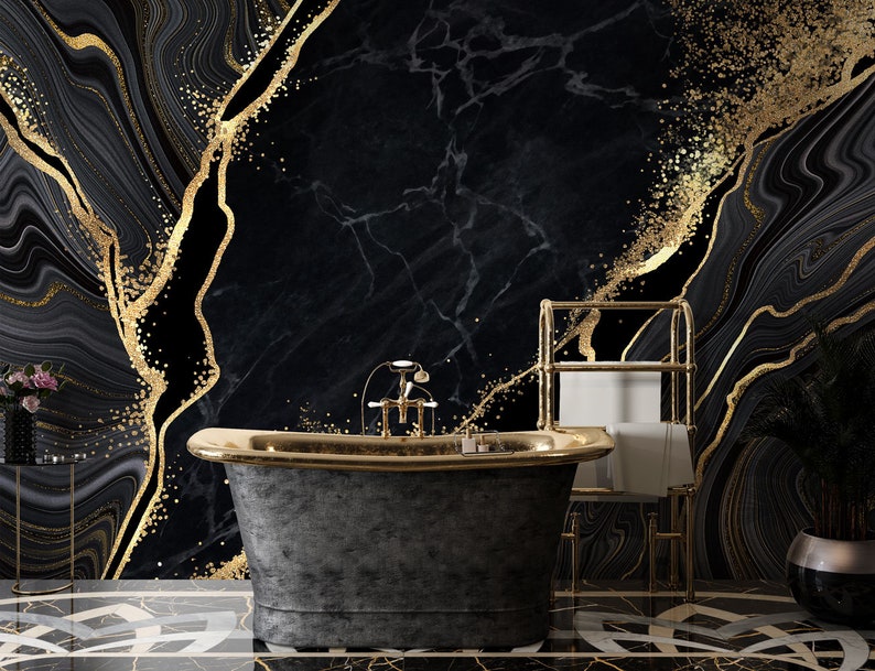 May include: A freestanding bathtub with a dark grey textured exterior and a polished gold rim, featuring a gold faucet. The background is a black marble wall with gold veining and glitter accents, and a gold towel rack stands to the right.