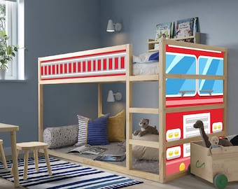 May include: A light-colored wooden bunk bed featuring a fire truck graphic design on the side panels. The design includes red, white, and blue colors with depictions of windows, a grille, and ladder details. The bed frame is made of natural wood.