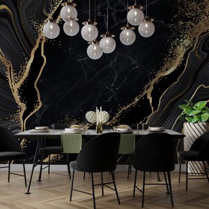 May include: A dining room featuring a black marble wall mural with gold glitter accents, a rectangular table with green runners, six black upholstered chairs, a cluster of nine spherical glass pendant lights, and a green plant in a white planter.