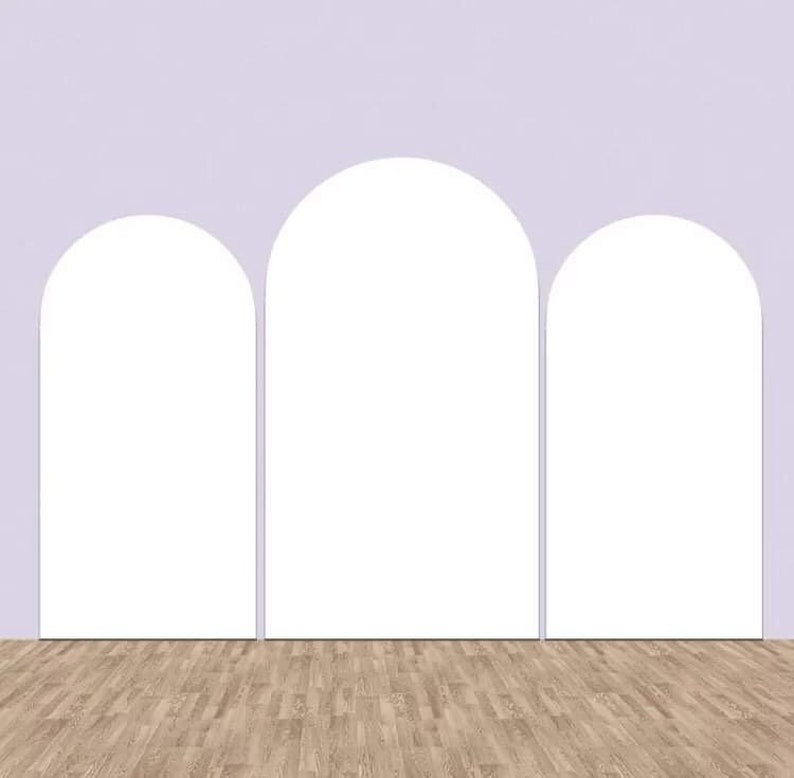 May include: Three white arches against a light purple wall with a wood floor.