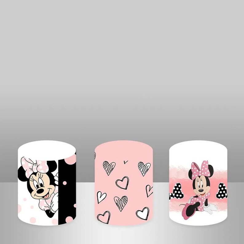 May include: Three cylindrical containers with different Minnie Mouse designs. The first container has a white background with pink polka dots and a black and white image of Minnie Mouse peeking out from behind a black polka dot pattern. The second container has a pink background with black and white hand-drawn hearts. The third container has a white background with a pink watercolor wash and a black and white image of Minnie Mouse sitting with her legs crossed.