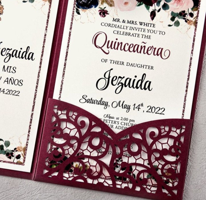 May include: Burgundy red laser cut invitation with a floral design and the text "MR. & MRS. WHITE CORDIALLY INVITE YOU TO CELEBRATE THE Quincea&ntilde;era OF THEIR DAUGHTER Jezaida Saturday, May 14th, 2022 Mass: at 2:00 pm PETER'S CHUR UR ADD"