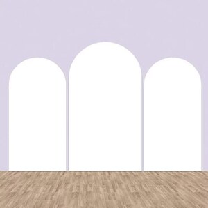 May include: Three white arches against a light purple wall with a wood floor.