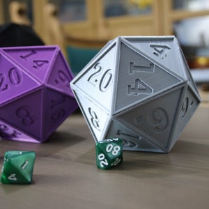 May include: Two 20-sided dice, one purple and one gray, with numbers 14, 20, 8, 16, 9, 1, 4, 6, 17, 20, 8, 9, 17, 14, 4, 1, 6, 10, 12, 3, and 20. There are also three smaller green dice with numbers 10, 20, 8, 16, 17, 7, 8, 20, 1, and 4.