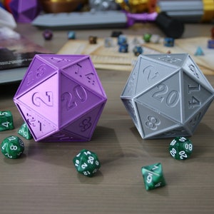 May include: Two 20-sided dice, one purple and one gray, with green 6-sided dice scattered around them.