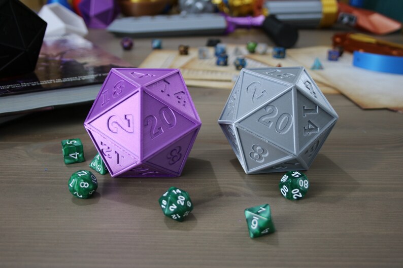 May include: Two 20-sided dice, one purple and one gray, with green 6-sided dice scattered around them.