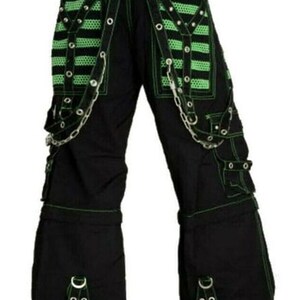 May include: Black cargo pants with green trim and silver chains. The pants have multiple pockets and buckles.