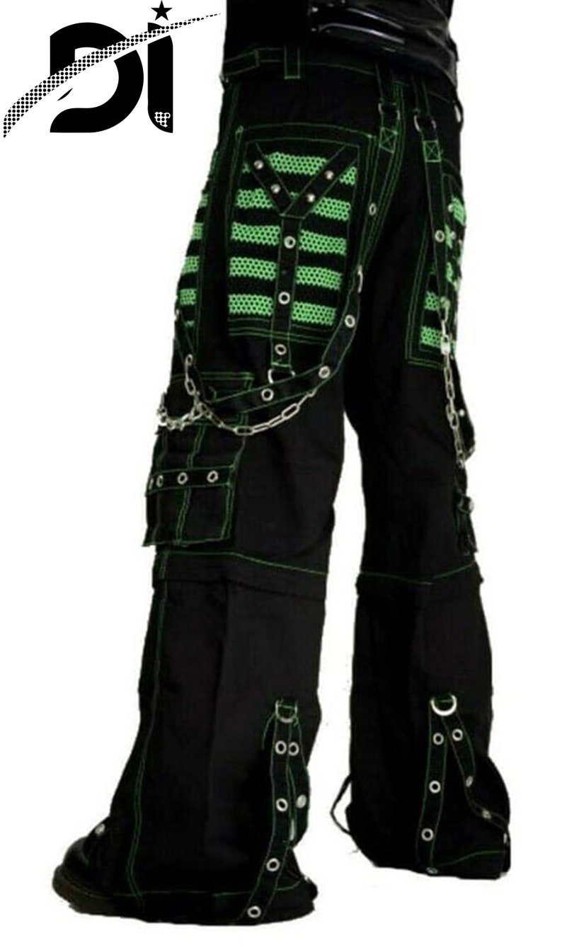 May include: Black cargo pants with green stitching and multiple straps and buckles. The pants have a chain detail and large pockets.