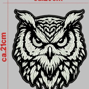 May include: Black and white embroidered iron-on patch of an owl's face. The owl has a fierce expression with large, dark eyes. The patch is approximately 8 inches wide and 8 inches tall.