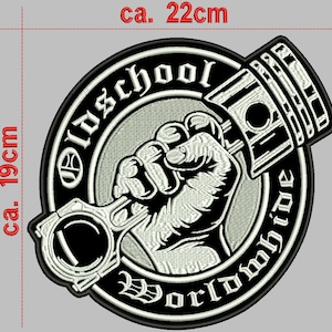 Op de afbeelding: Zwart-witte geborduurde patch met een vuist die een zuiger vasthoudt. De patch is rond en heeft de tekst "Old School Worldwide" rond de rand.