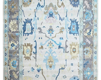 May include: A light blue and gray rug with a traditional Persian design. The rug has a white background with intricate patterns in shades of blue, brown, and pink.