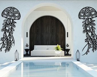 May include: Two black metal wall sculptures of jellyfish with intricate floral designs hang on a white wall in a modern home with a swimming pool.