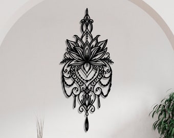 May include: Black metal wall decor featuring a large, intricate lotus flower design with dangling beads and swirls. The design is reminiscent of a mandala or a dreamcatcher.