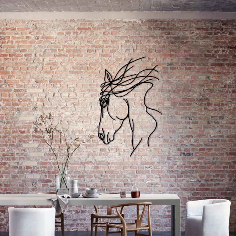May include: A black metal horse head silhouette wall decor with a flowing mane, mounted on a brick wall above a dining table with chairs.