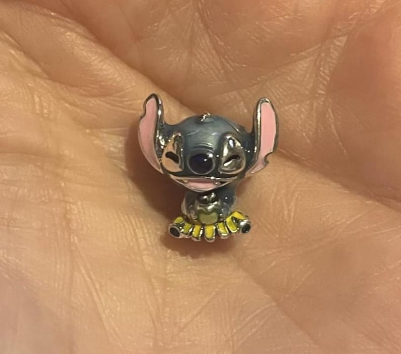 May include: A white ceramic mug with a black handle and the text "But First, Coffee" in a handwritten style. The mug is on a white surface. The mug is approximately 10 cm tall.