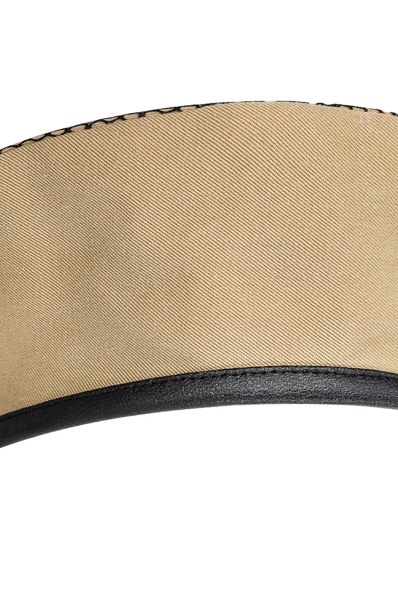 May include: A beige beret with a black leather band around the bottom edge.